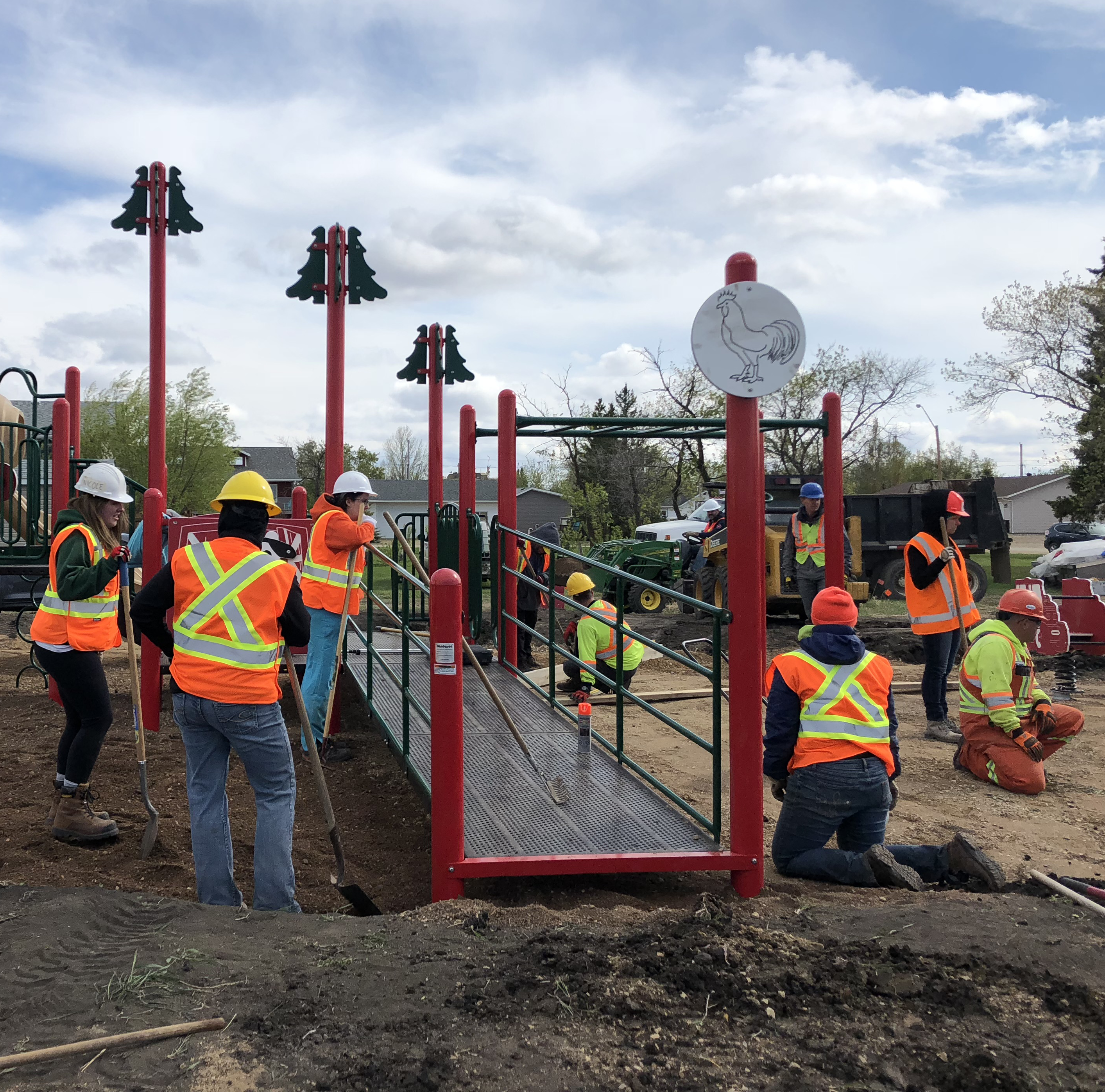 a dozen volunteers setting up a public playground