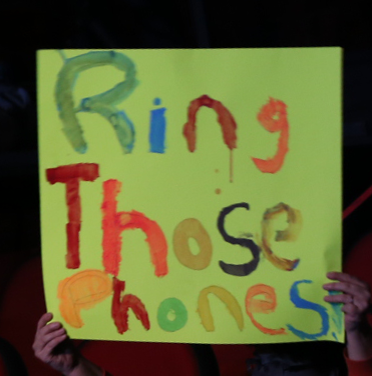 homemade paper sign, with letters that reads Ring Those Phones