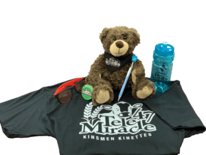 selection of TeleMiracle merchandise like t-shirt, teddy bear, and water bottle