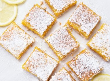 Dessert lemon bars over baking paper, top view